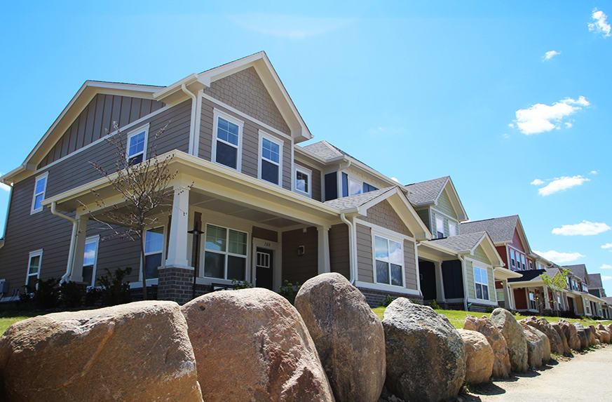 view from sidewalk looking up to homes